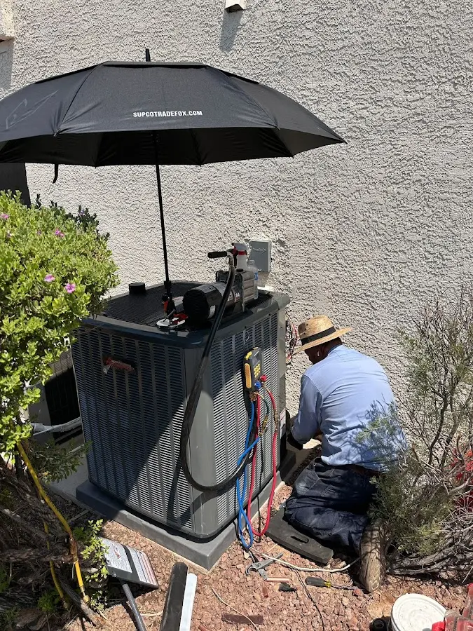 HVAC technician performing outdoor AC maintenance in Statesville