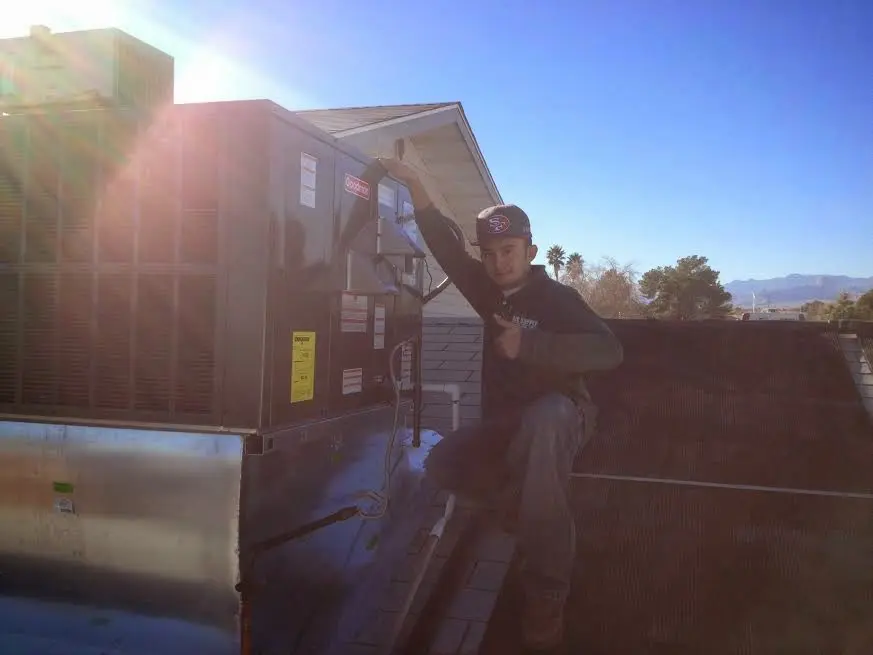 HVAC technician performing HVAC Inspection on a rooftop unit in Statesville